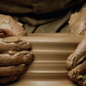 hands making a ceramic pot